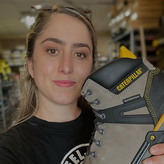 Woman holding a work boot