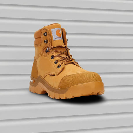Yellow work boot with Carhartt logo on a metallic background