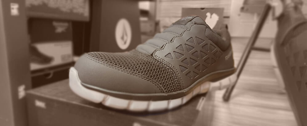 "Slip-on steel-toe work shoes with mesh upper and flexible outsole."