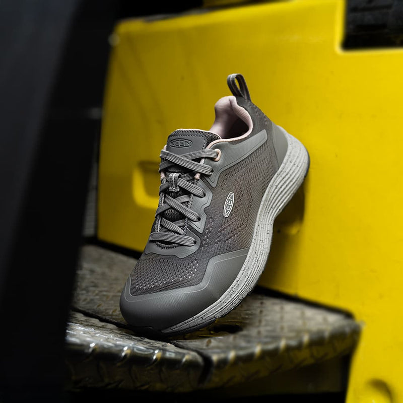 Close-up of women’s steel toe work shoe on jobsite floor